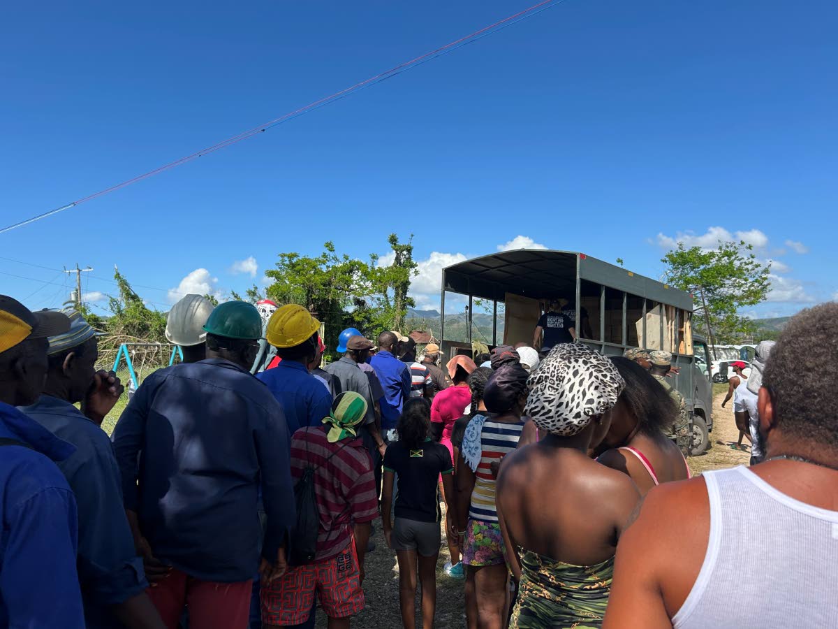 Residents from Frome and surrounding communities in Westmoreland line up to receive a filter system.