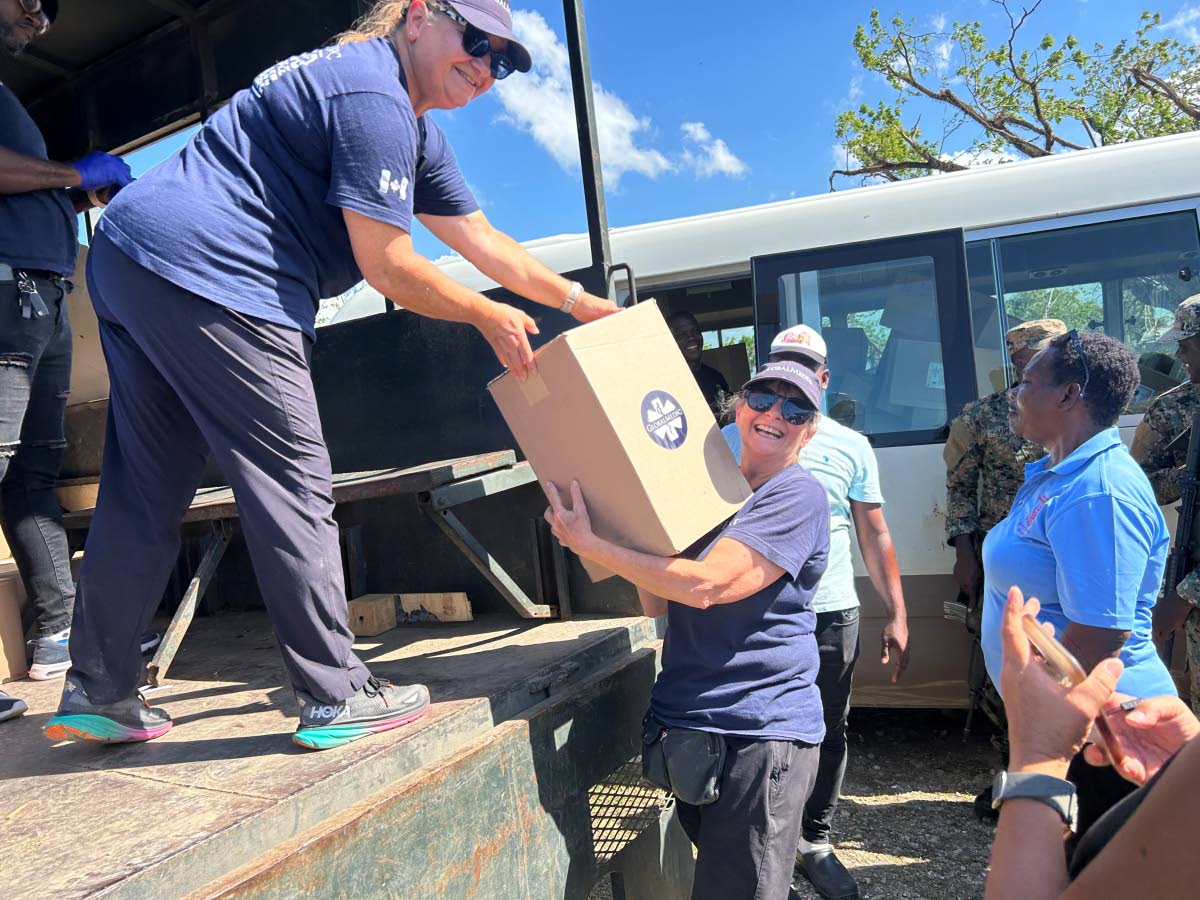 Beth Robertson (left) and Lori Stross from the Global Medic team distributing the packages.