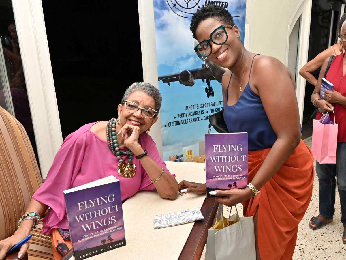 Sandra D. Cooper (left) signed a copy for Annabelle Thomas, who contrasted a navy blue camisole with a warm rust faux-wrap skirt. 