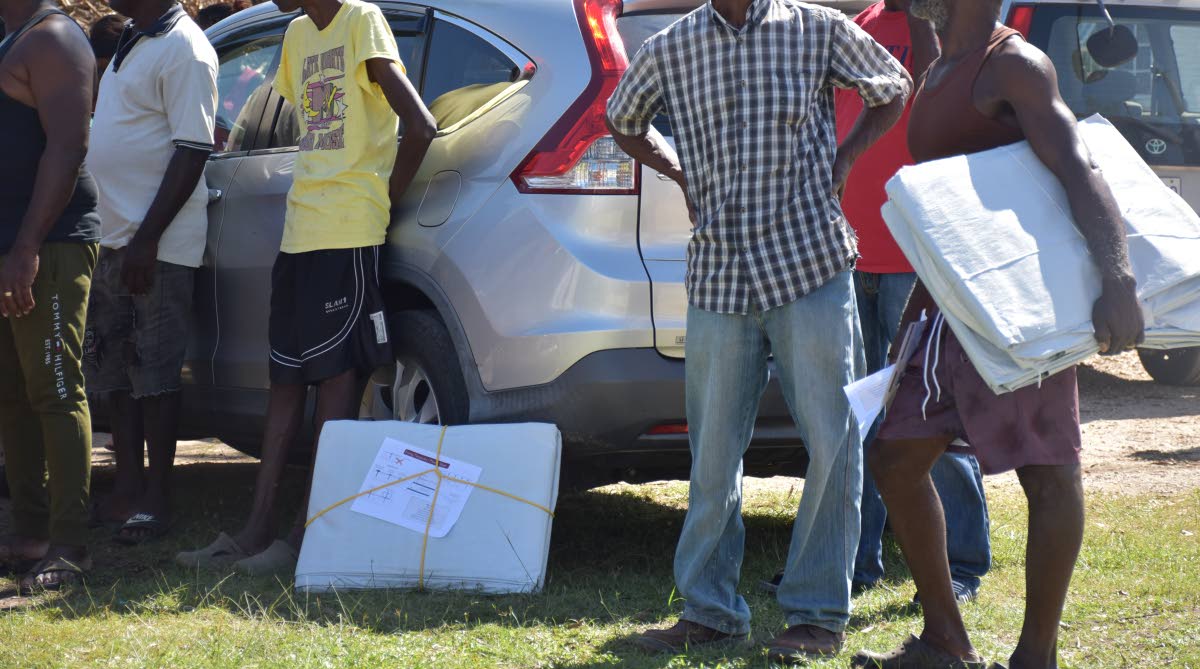 The IOM distributes tarpaulins to citizens in Westmoreland during hurricane relief operations last week.