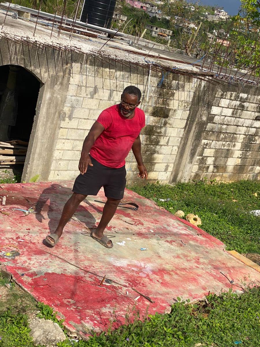 During the RG CARES visit on November 23, Lima resident  Coral Johnson, stands on the foundation of his former one-room home, explaining how Hurricane Melissa demolished it.