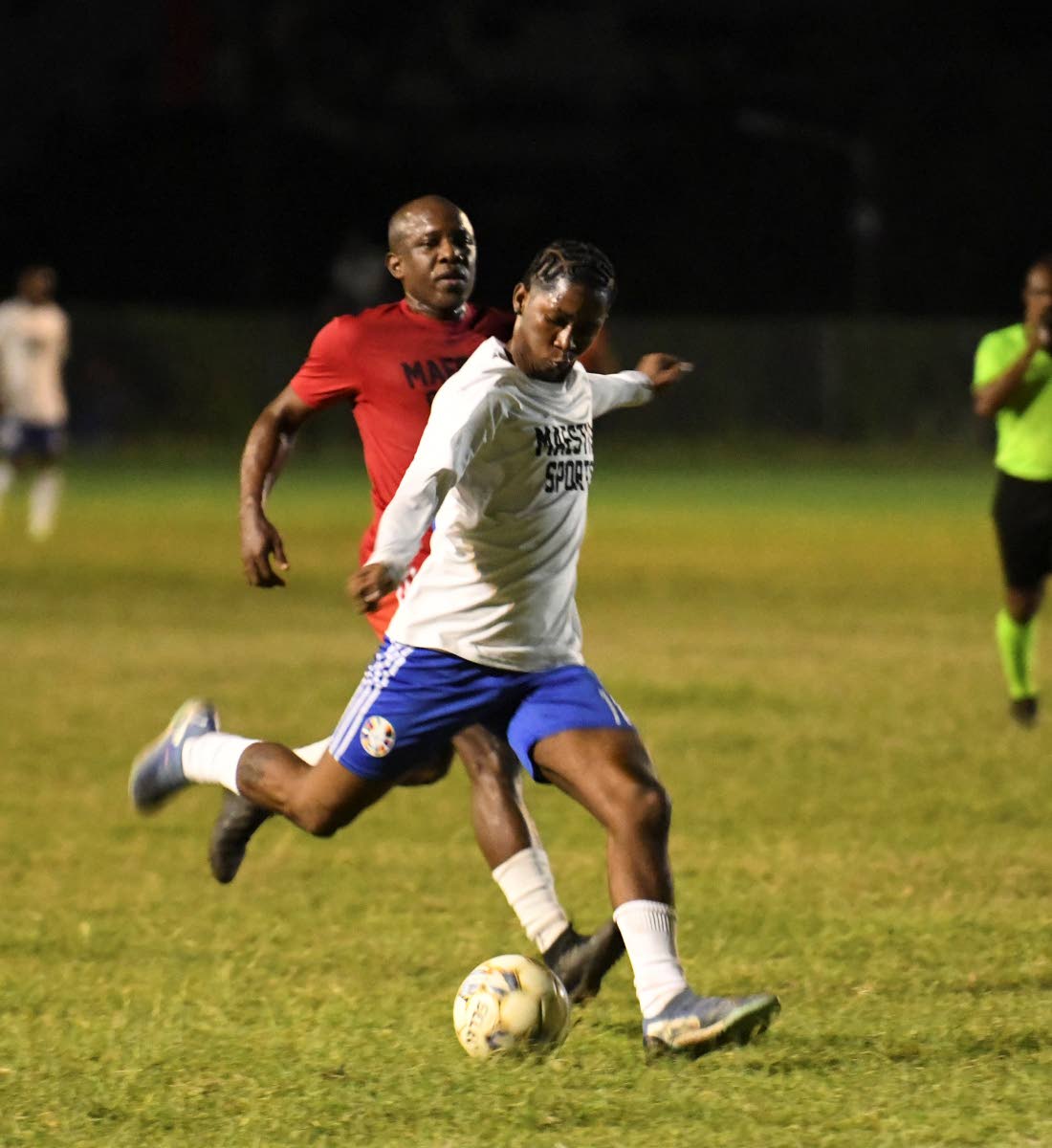 Kaka Highflames (front), Tik Tok creator, keeps possession as entertainer Wayne Marshall closes in.