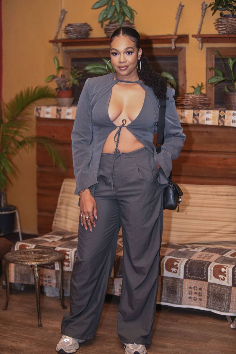 Media personality and host for the night, Ashley Miller, goes athleisure-cool in a grey tie-front jacket, sweats, and trainers.