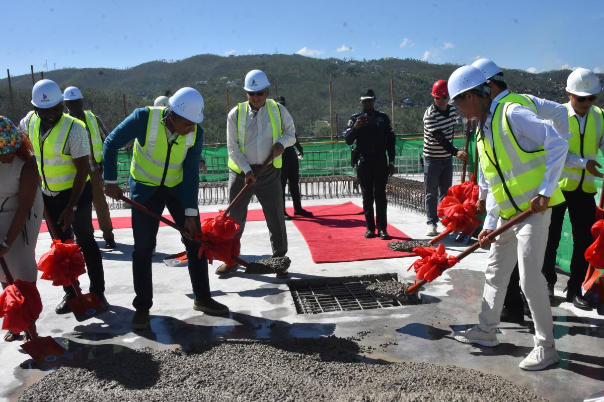 Prime Minister Dr Andrew Holness and executives of LCH Development topping out Tower One at The Pinnacle Montego Bay in St James yesterday.
