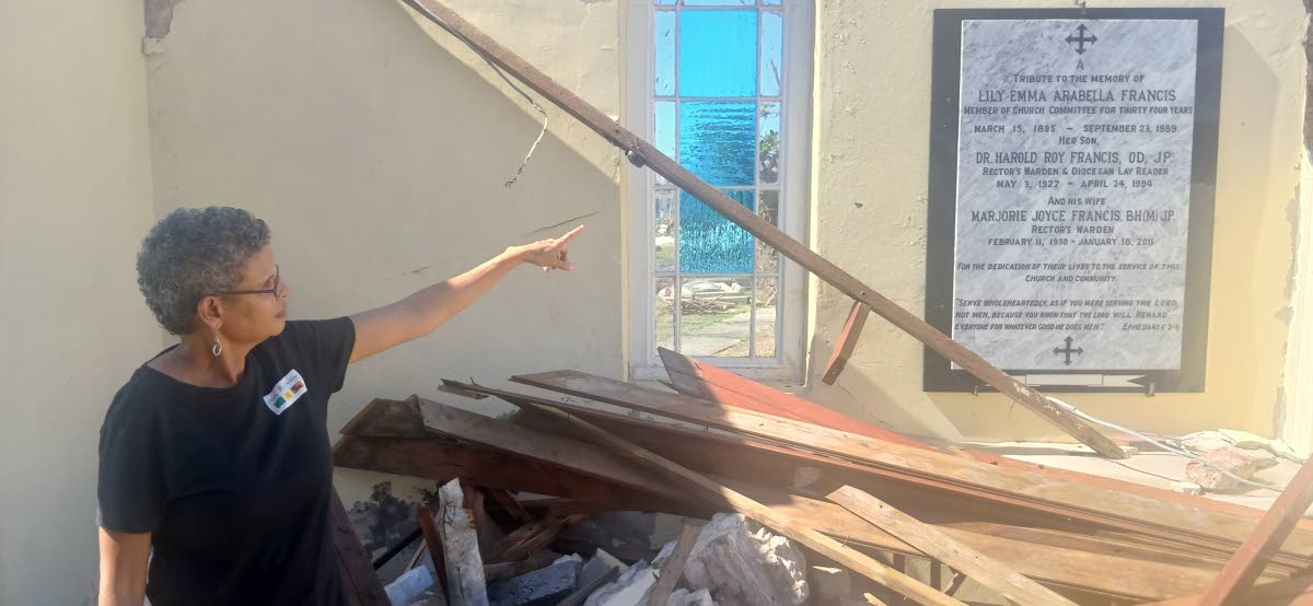 Paul Williams Photos 
Allison Morris points to the marble plaque mounted in honour of her parents and grandmother in St John’s Parish Church in Black River, St Elizabeth.