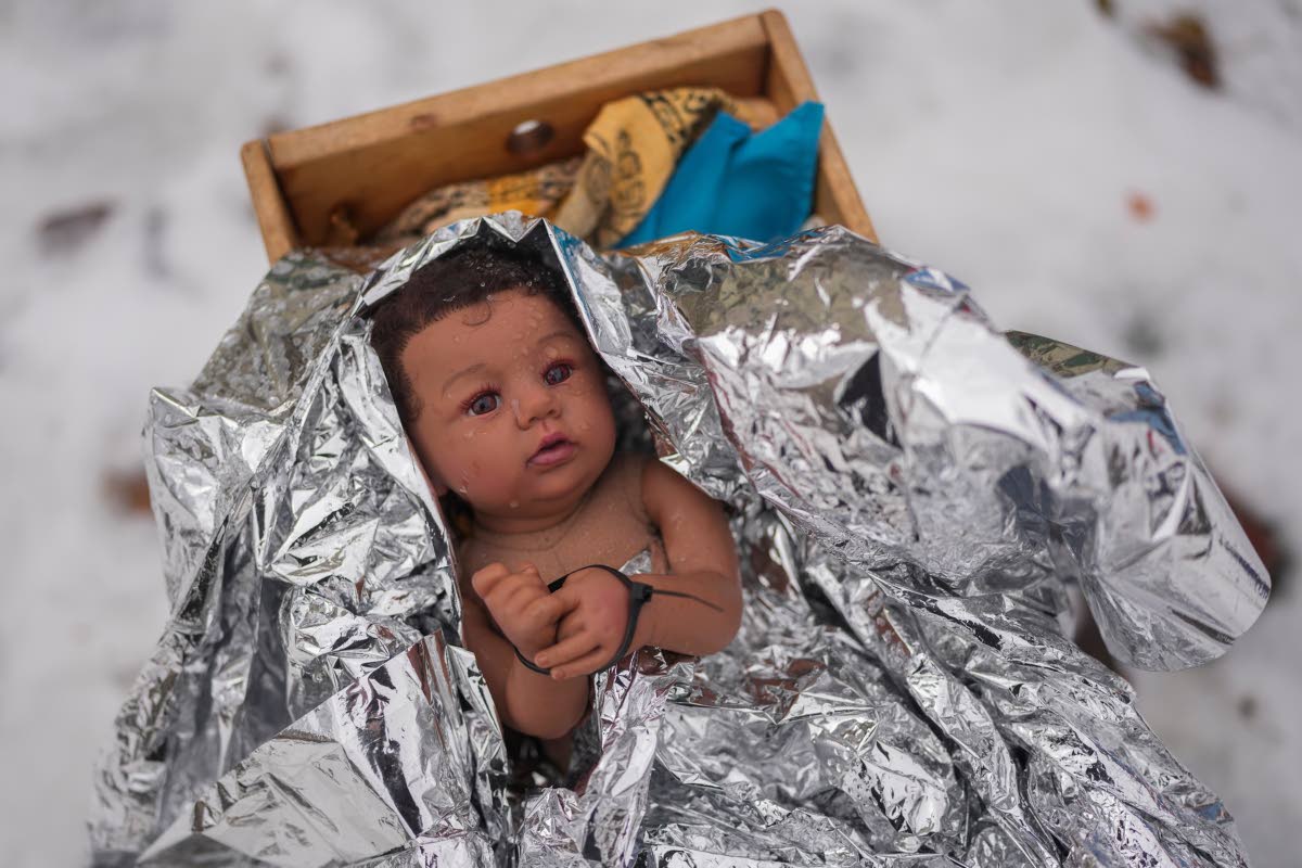 AP 
A doll representing the baby Jesus is zip-tied in the Nativity scene outside of Lake Street Church of Evanston in Evanston, Illinois on December 10.