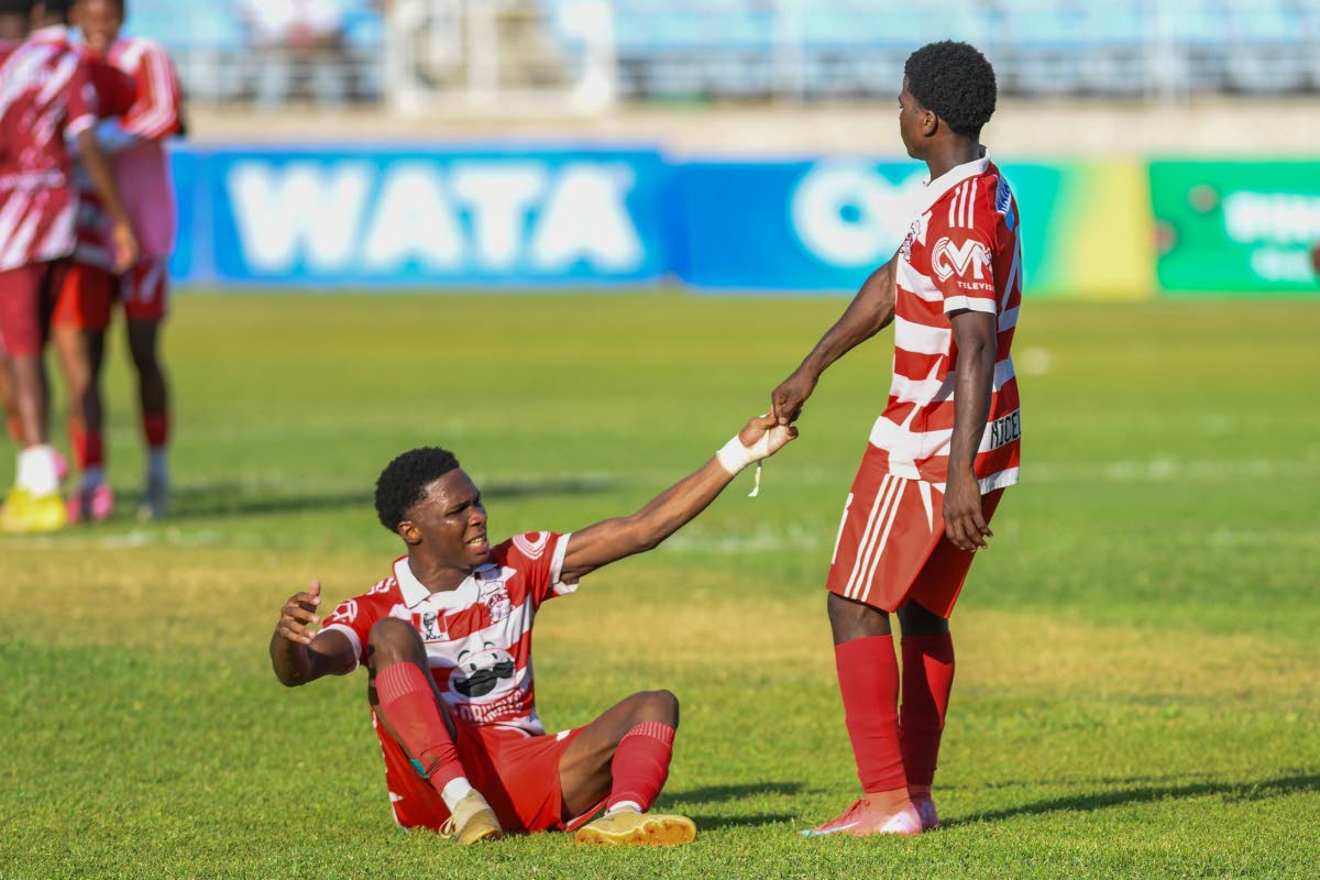 Glenmuir High School’s Tequaianne Allen is helped up by teammate Conroy Nicely during their ISSA daCosta Cup semi-final game against Dinthill Technical High School at Sabina Park yesterday. Glenmuir won 2-1.