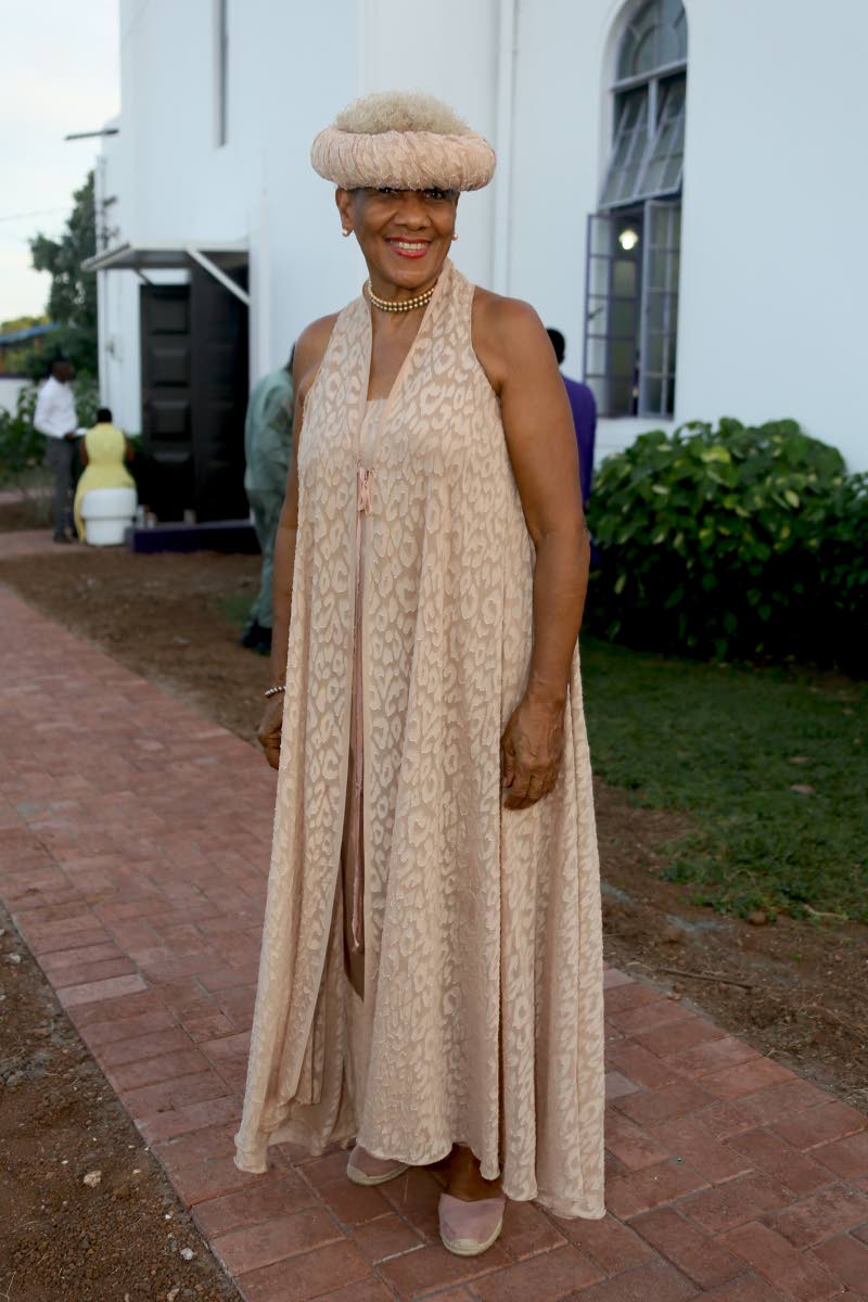 Dr Sherrill Chong delivers elegant style in a neutral maxi dress paired with a matching headscarf tied in a Heidi braid.