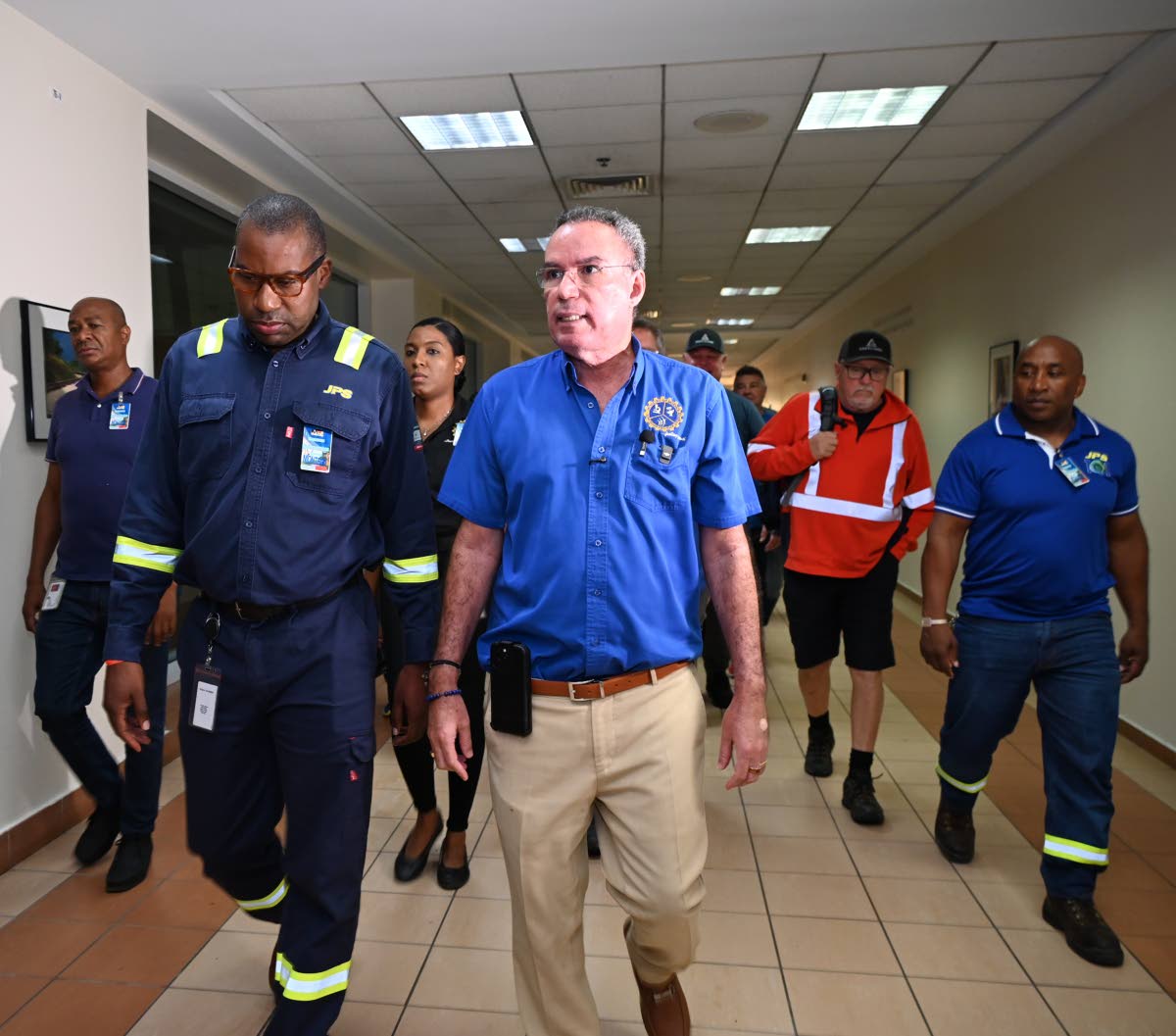 Hugh Grant (left), CEO of the Jamaica Public Service, and Energy Minister Daryl Vaz in discussion during the arrival of 117 linesmen from Canada at the Sangster International Airport in Montego Bay, St James, on Wednesday.