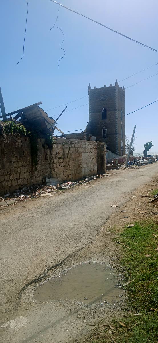 From afar it looks like the St John’s Anglican Church in Black River was left standing after Hurricane Melissa, but only the bell tower was.