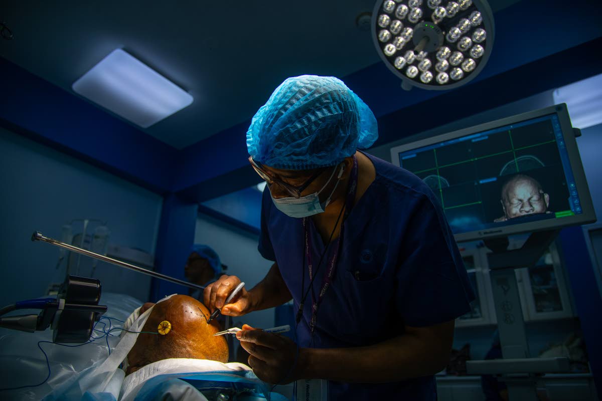 
Neurosurgeon Dr Roger Hunter marks guidelines along the scalp of a patient to perform a craniotomy where a right frontal mass (tumour) is be removed.