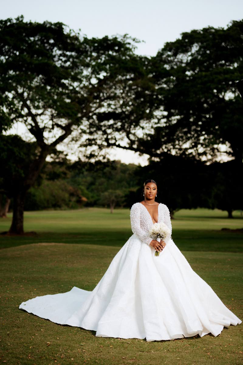 Wearing a white fit-and-flare wedding gown with a flowing train, the bride captivated everyone in attendance.