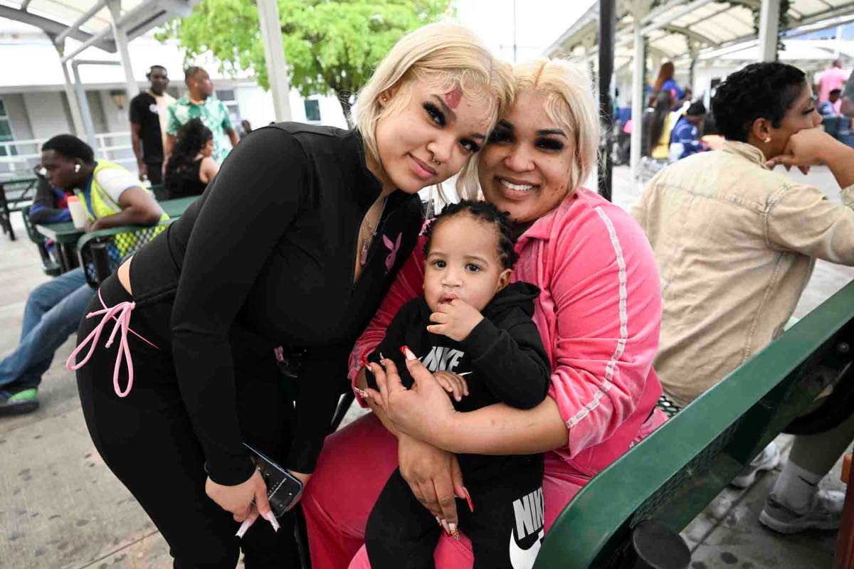 Alliah Moore (left) poses for a photo with her sister Amber Moore and nephew Aiden after the trio arrived on Monday.