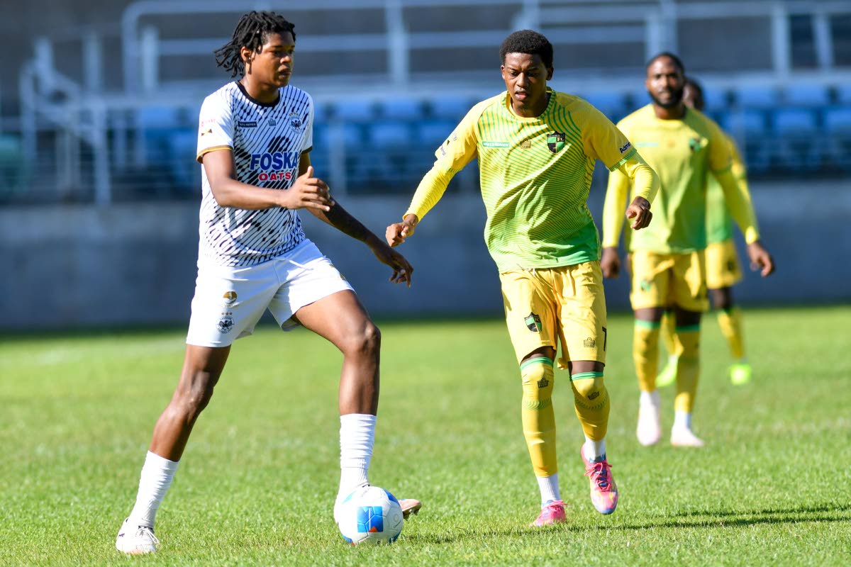 Micheal Forbes (left) of Cavalier clears the ball away from Karim Bryan of Treasure Beach during a Jamaica Premier League match at Sabina Park all the way back in September.