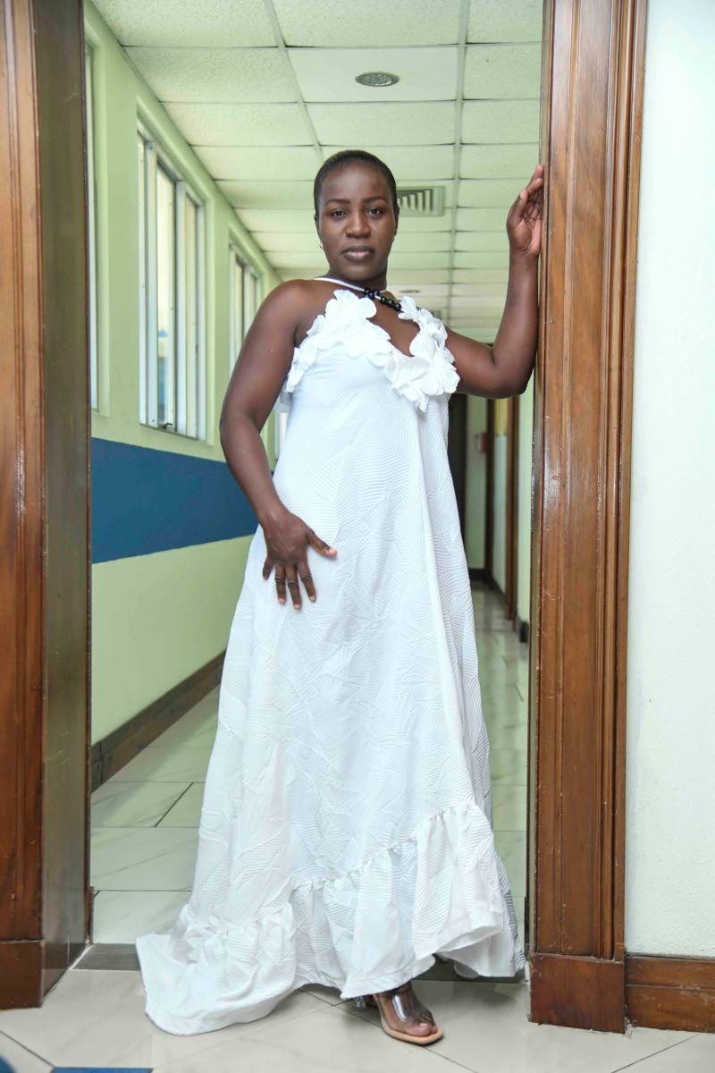 Adorned in a white maxi dress, model Shanakaye Edwards presents this statement look from Bebie Powell Designs.