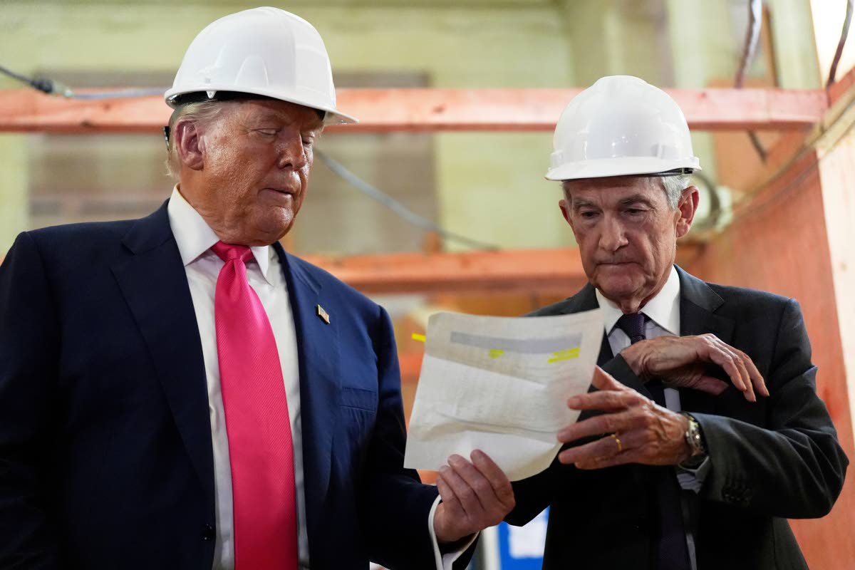 Federal Reserve Chairman Jerome Powell, right, and President Donald Trump look over a document of cost figures during a visit to the Federal Reserve, Thursday, July 24, 2025, in Washington. (AP Photo)