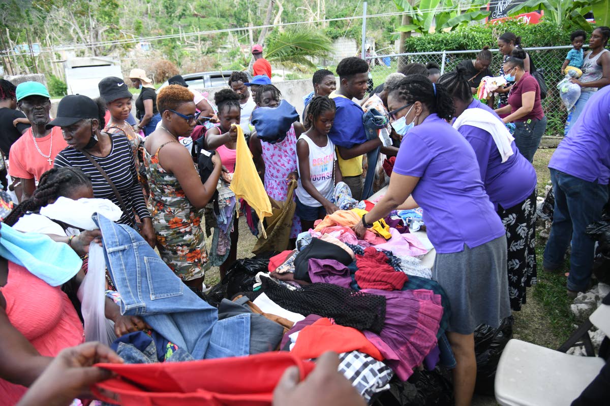 Residents of Shrewsbury search through clothes being provided to them by Faith Chapel of Faith Apostolic Ministries Health and Welness Department at the Mother Lewis AME Church in Shrewsbury, Westmoreland. 