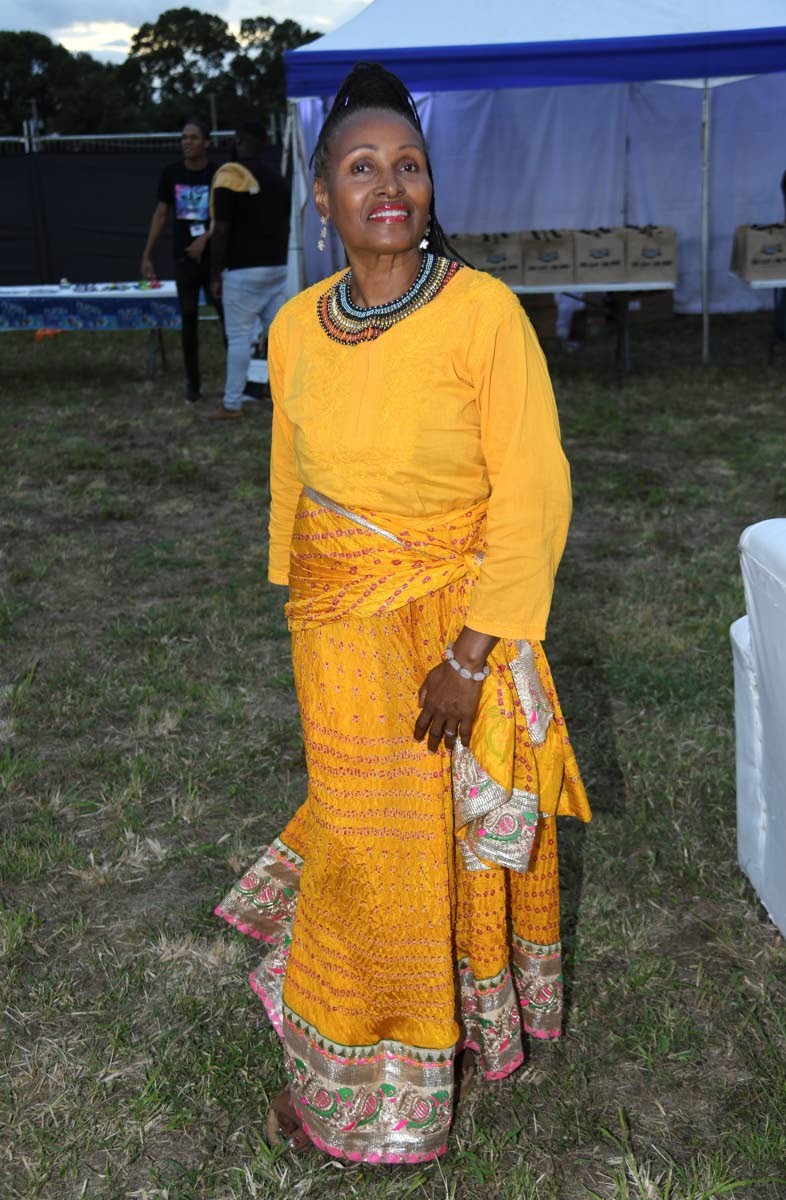 Sharon Parris-Chambers, public relations specialist at Carib Newsroom, dons a vibrant mustard ensemble, with a standout African-print skirt.