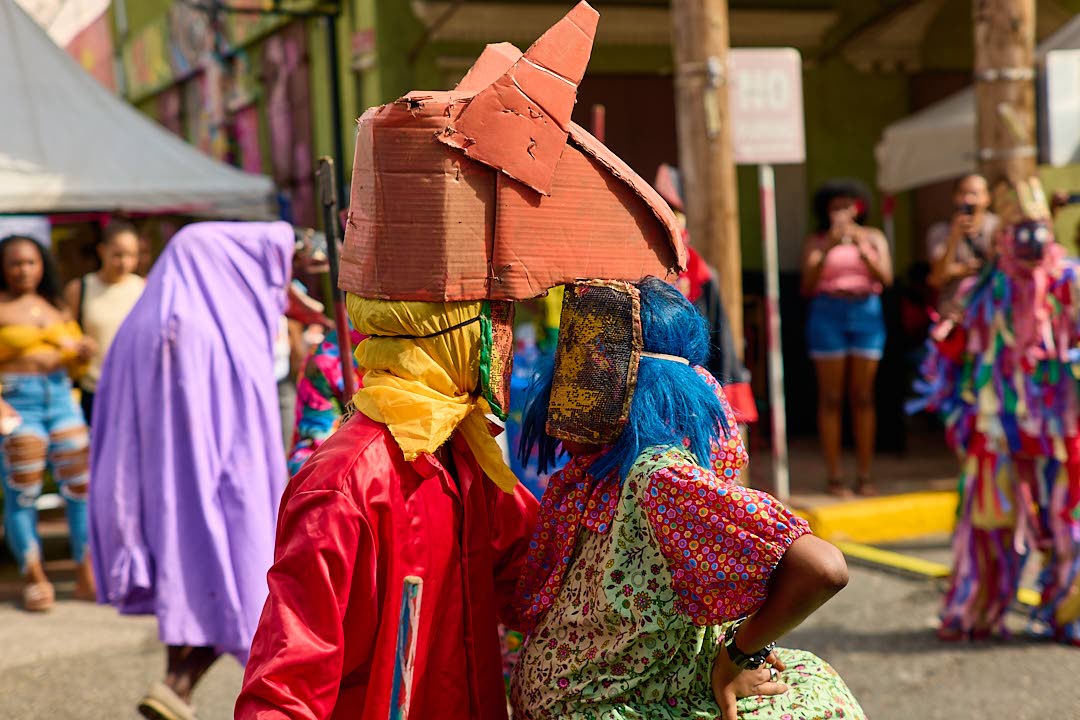 Jonkunnu characters Horse Head (left) and Belly Woman perform at the Sunday, December 21, Artwalk Festival Gran’ Market.