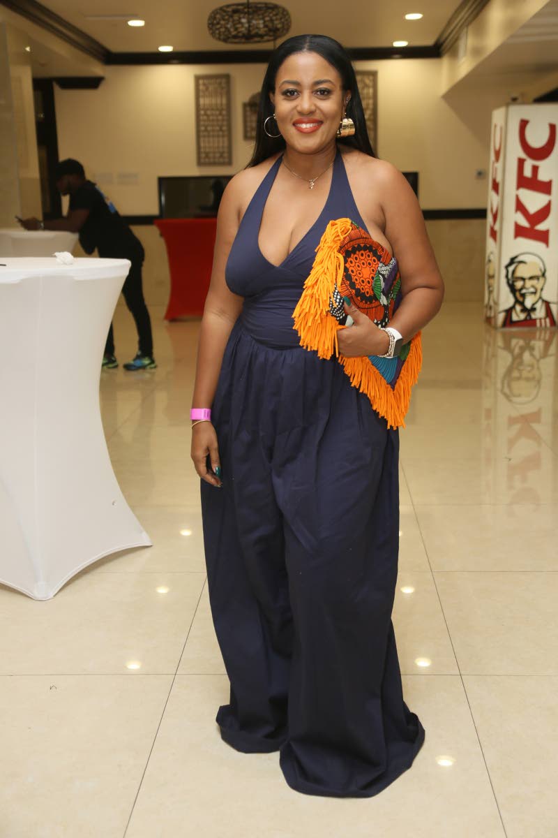 Life coach Nickeisha Powe paired a Fashion Nova jumper with a statement Zephiniah clutch.