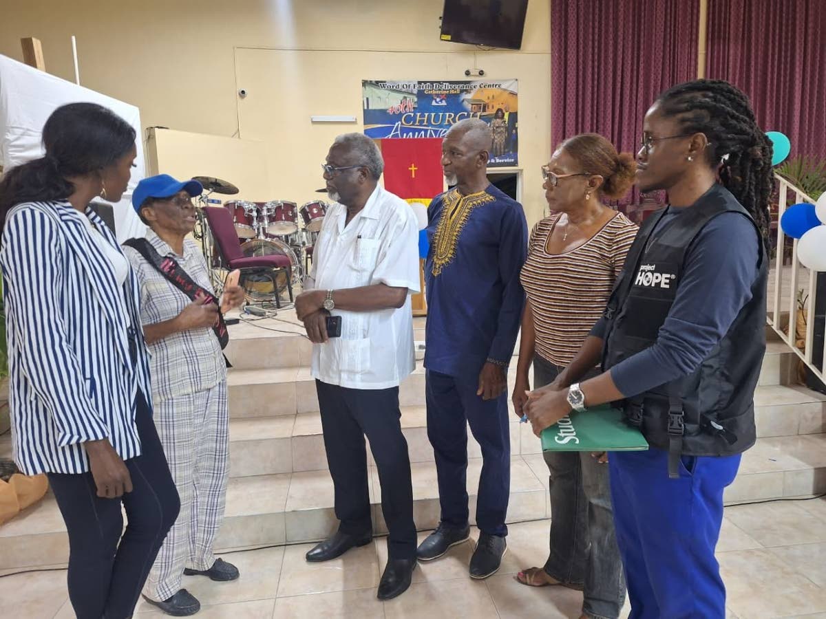 From left: Tishauna Mullings, mental health and psychosocial support (MHSS) coordinator with Project HOPE; Gloria Reid, an 86-year-old resident of Catherine Hall; Bishop Conrad H. Pitkin, Custos of St James; Bishop Wellesley Plummer, pastor of the Word of 