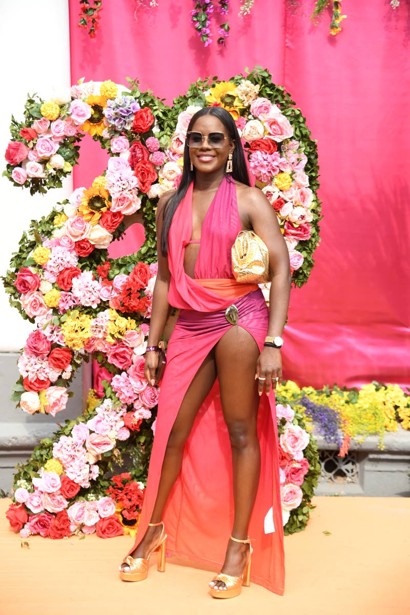 Shanice Bailey, property manager, brings the heat in a pink ombré Murci piece, complete with a draped neckline, thigh-high slit, and sparkling gold waist detail.