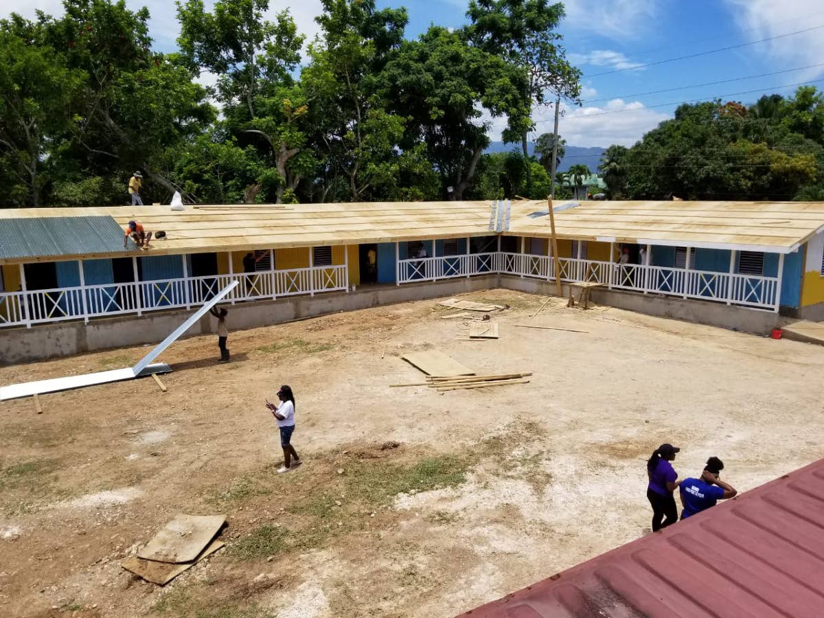 Helping Hands Foundation volunteers work to repair a school.