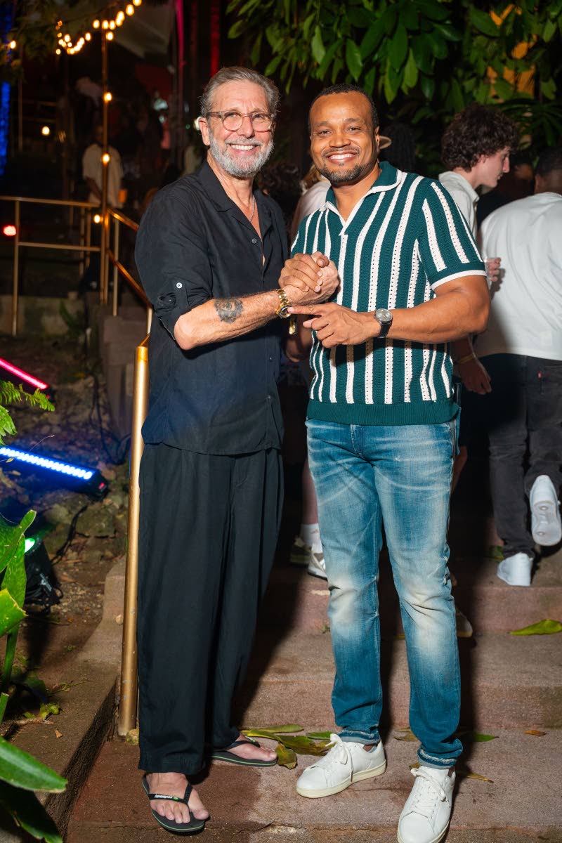 Music industry executive and owner of Geejam, Jon Baker (left), and Heineken Brand Manager Nathan Nelms mark the occasion with a gesture of camaraderie.