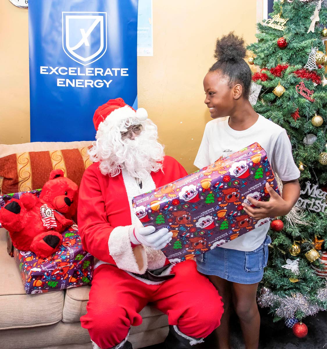 Oneika Broomfield of Old Harbour Bay is thrilled to receive a gift from Santa during the toy donations held at the Old Harbour Bay Community Centre. 