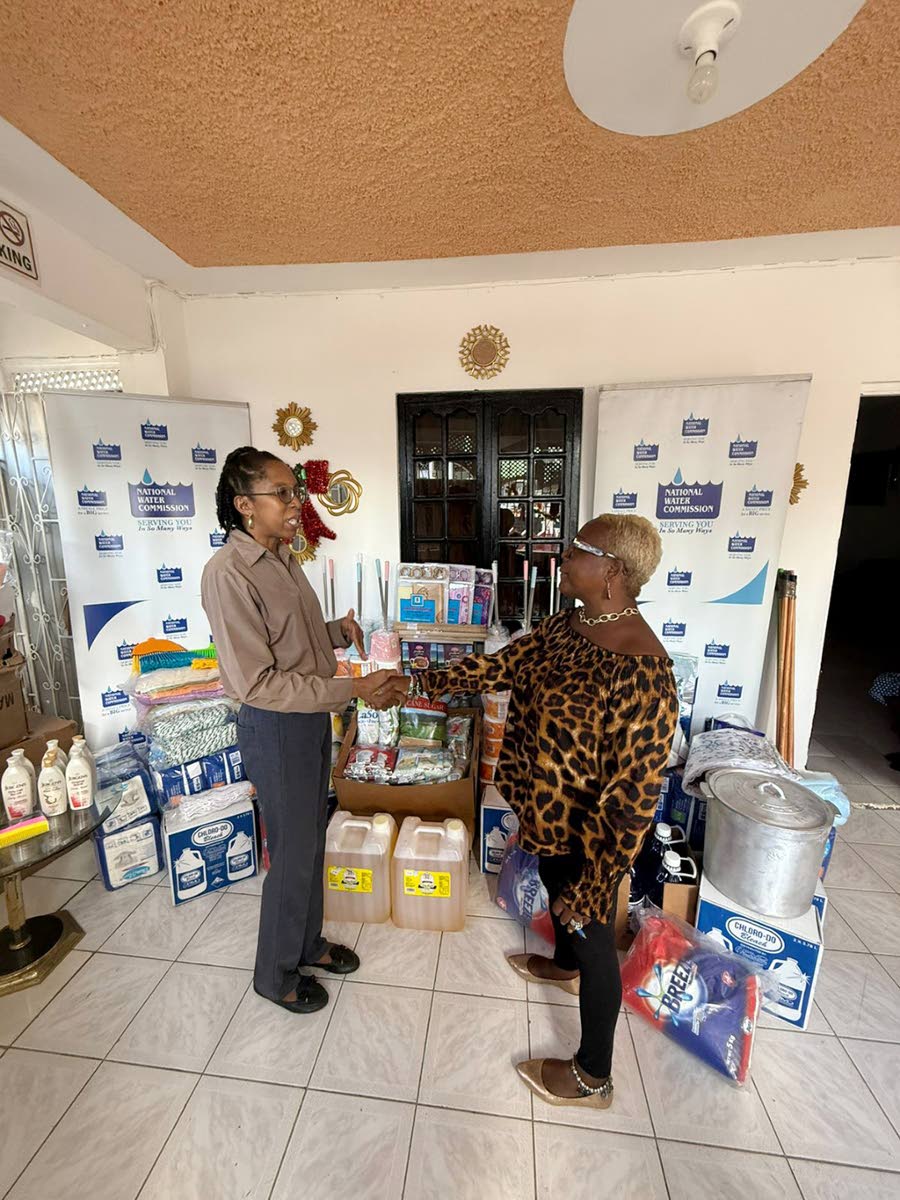 Acting Community Relations Manager (eastern), Ann Bolt (left), hands over donated items to Sandy Frazer-Jackson, manager of the Ultimate Care Home, during a presentation at the facility in Catherine Hall, St James.