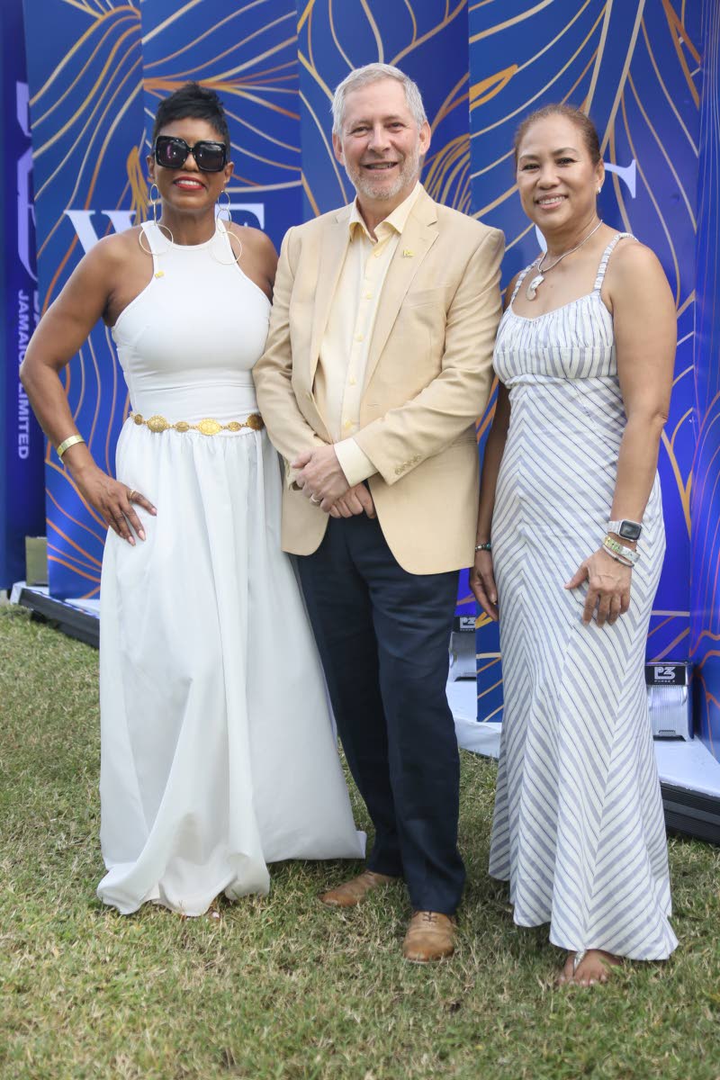 Chief Executive Officer of National Commercial Bank, Bruce Bowen, stands proudly with members of his team, Audrey McIntosh (left), head of private banking, and Carlene Lyn, vice-president of corporate banking.