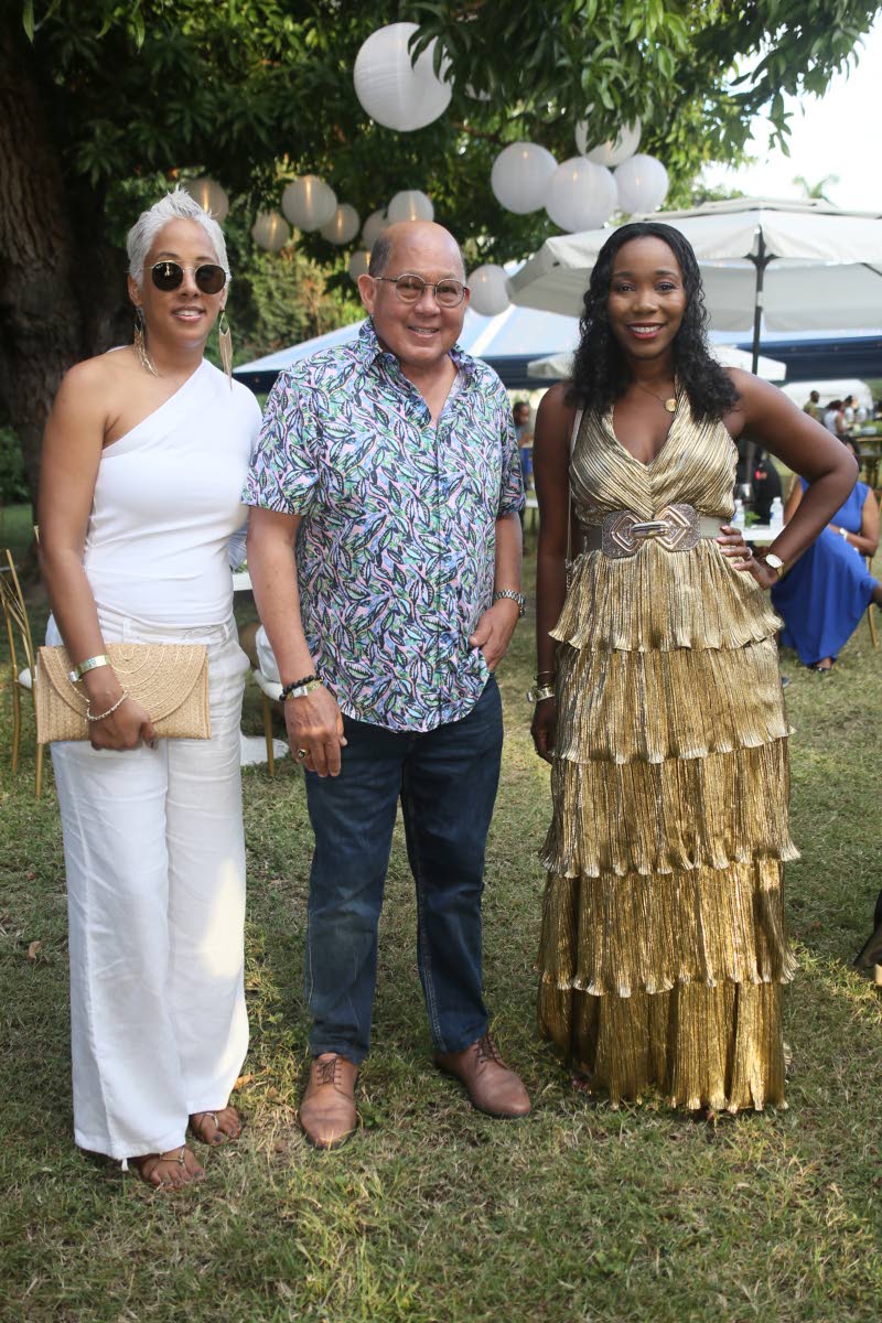 Chairman of Coldfield Manufacturing Ian Wong is honoured to be in the presence of beauties Nadia Jervis (left), senior relationship manager, NCB, and Kimberly Martin, assistant vice-president of corporate solutions and syndication at NCB Capital Markets Li