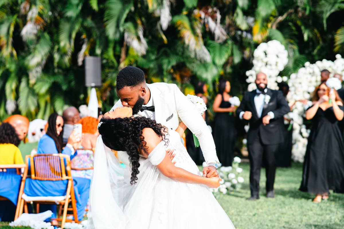 Adriel and his bride, Danielle, share a kiss.