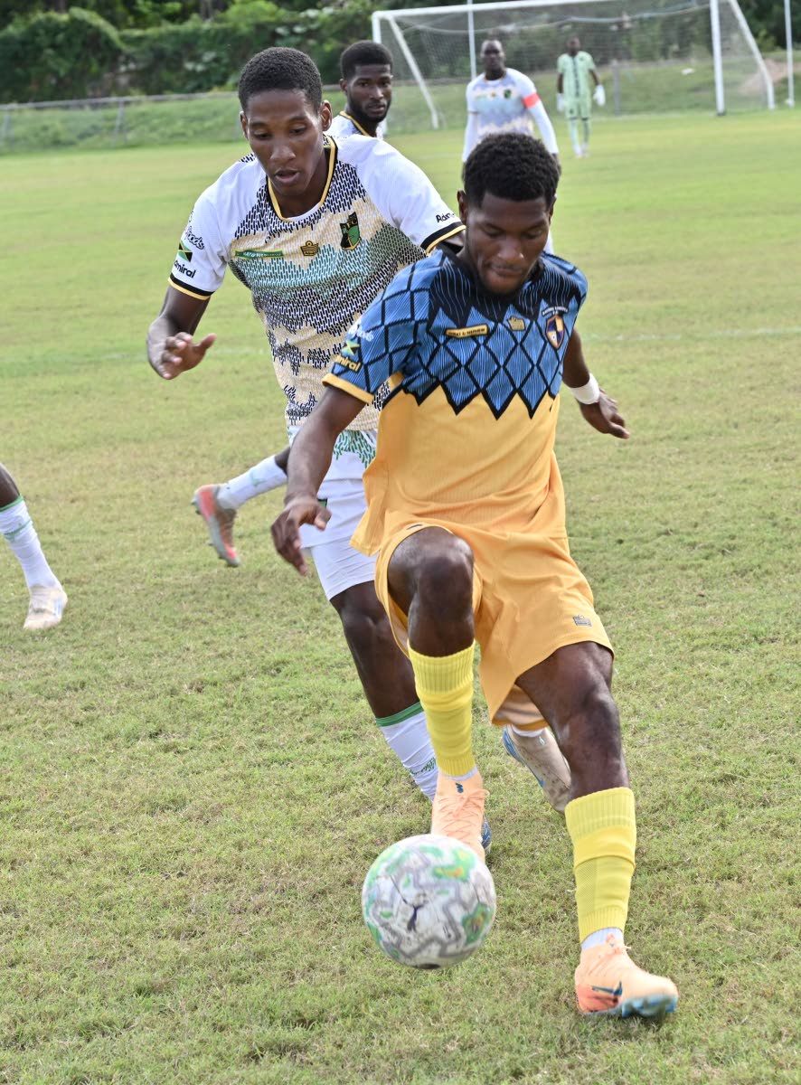 Racing United’s Tajay Ajani (right) controls a ball while under pressure from Treasure Beach’s Daniel Hardy during a Jamaica Premier League football match at the Ferdi Neita Park yesterday. Racing won 4-1.