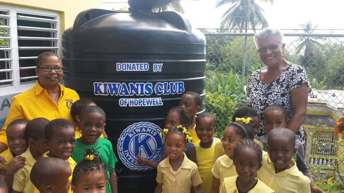 Incoming Kiwanis International President Hope Markes (left) and Kiwanian Laura Bryan share lens time with students of Haddington Basic School, where they donated a water tank, in collaboration with the Kiwanis Club of Toronto, Canada. 