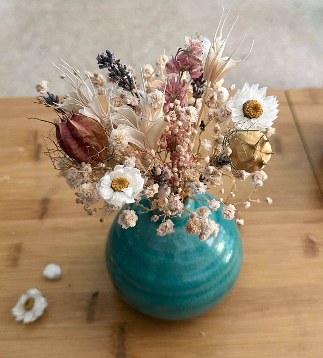 An artful dried floral arrangement with wildflowers, striking nigella pods and aromatic lavender.