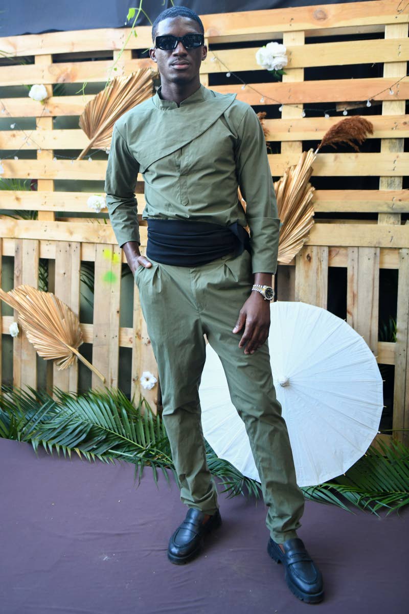 Azeim Johnson rocks an army green pantsuit with a pop of black, designed by Lucien Harrison.