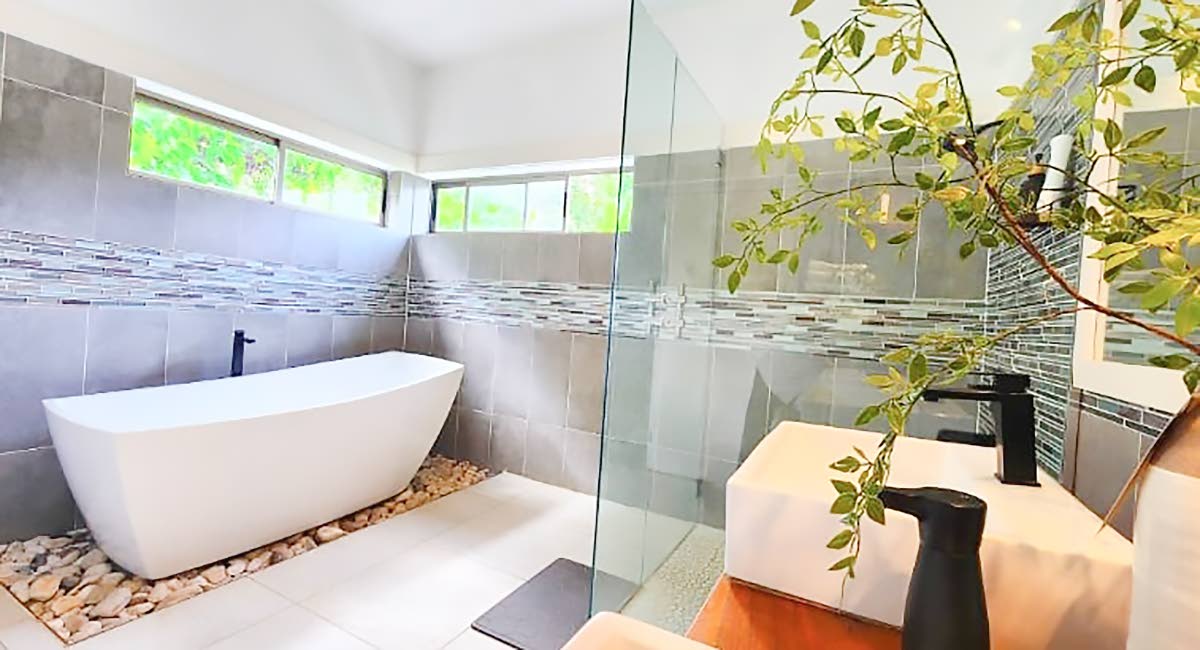 In vogue spa bathrooms astonish with soaking tubs in sunken beds of stone.