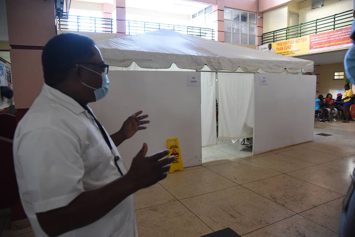 Mandeville Regional Hospital CEo Alwyn Miller explaining the purpose of the tent inside the Accident and Emergency Department.