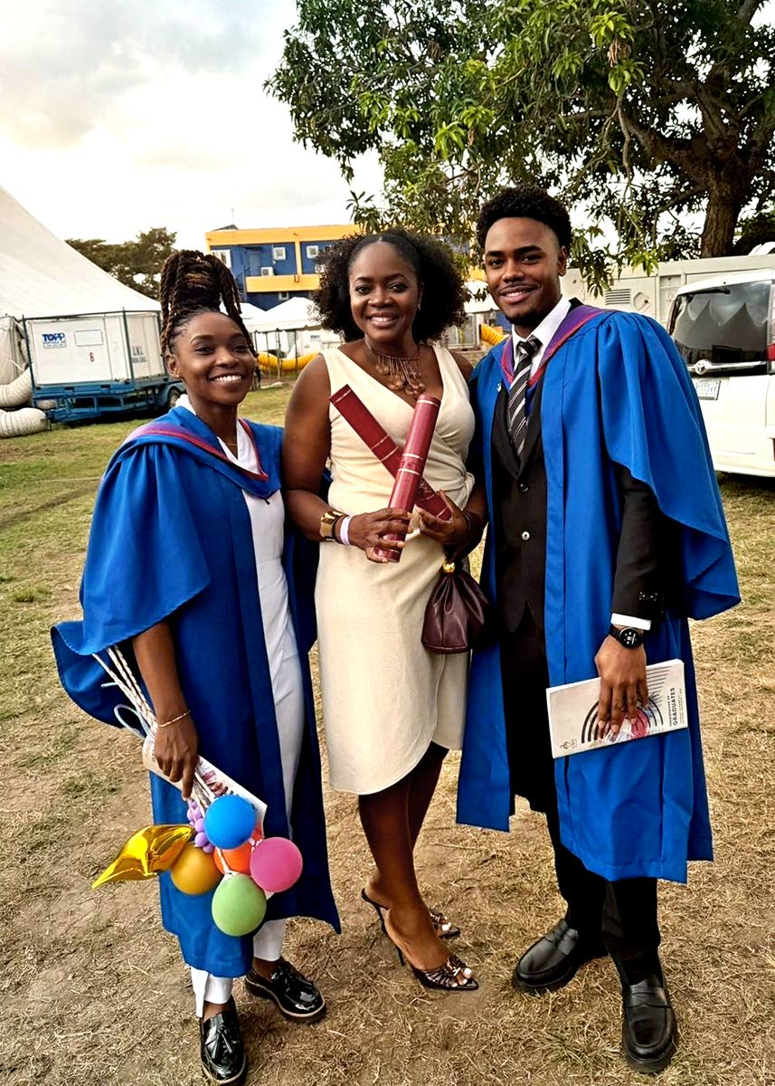 Heather Green celebrates with her children Kimberly Clarke (left) and Anton Goode, who both graduated from The University of the West Indies on Thursday. 