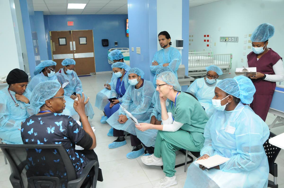 Kenyan-based consultant intensivist Dr Kabui Kasuongo (front left), instructs a team of nurses from the Bustamante Hospital for Children Cardiac Centre on post-operative care best practices and skills to support children following surgery.