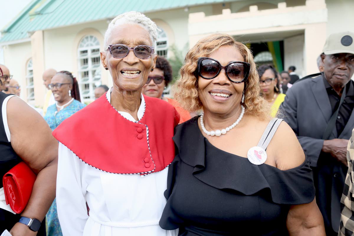 Sister Myrel Moss shares a light moment with Melrose Lumsden following the funeral of Alvarene Roberts, at St Gabriel’s Anglican Church, May Pen, Clarendon, yesterday.