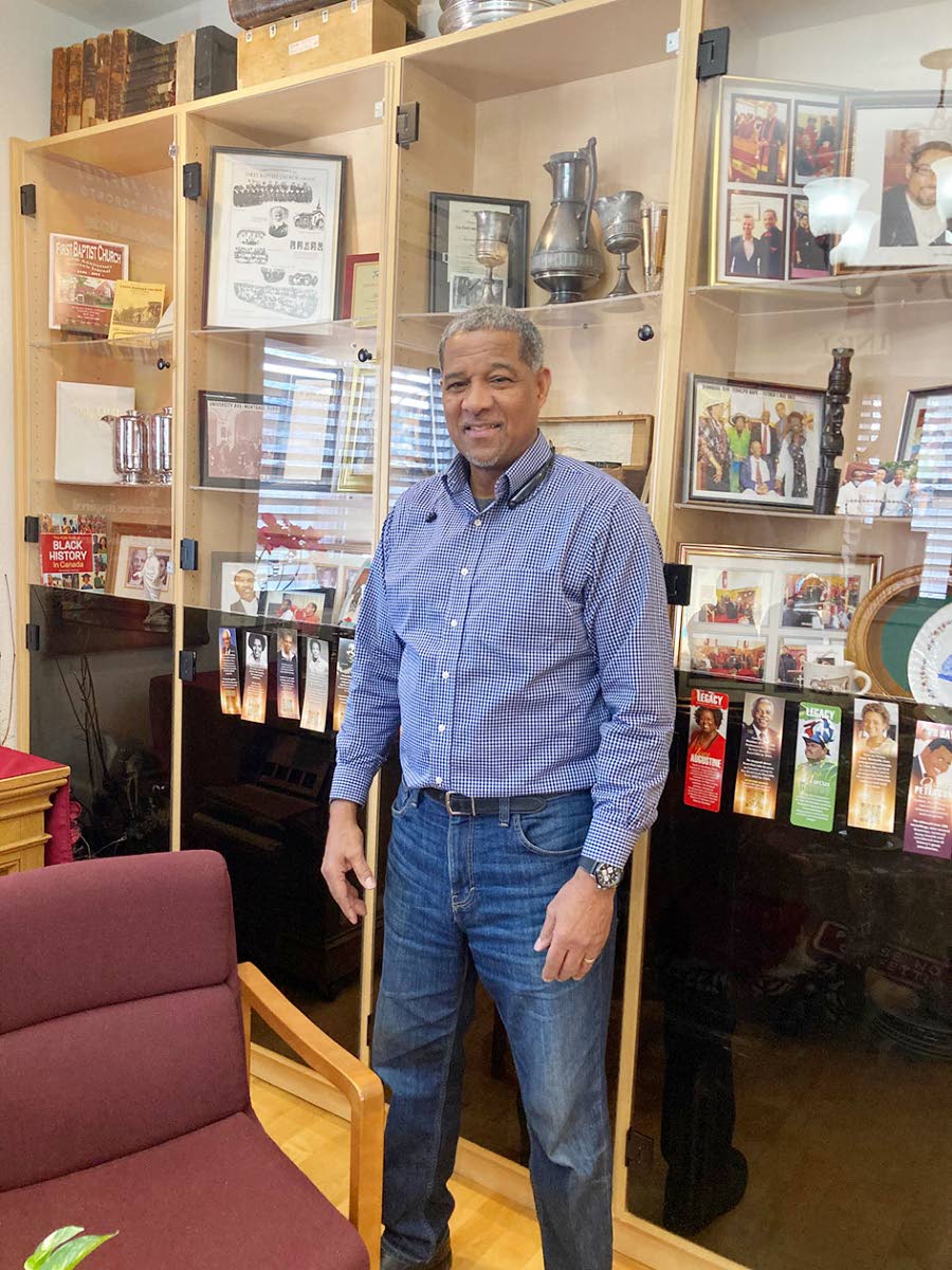 Rev Dr Wendell Gibbs, senior pastor of First Baptist Church Toronto, standing in the Penny Hodge Heritage Room.