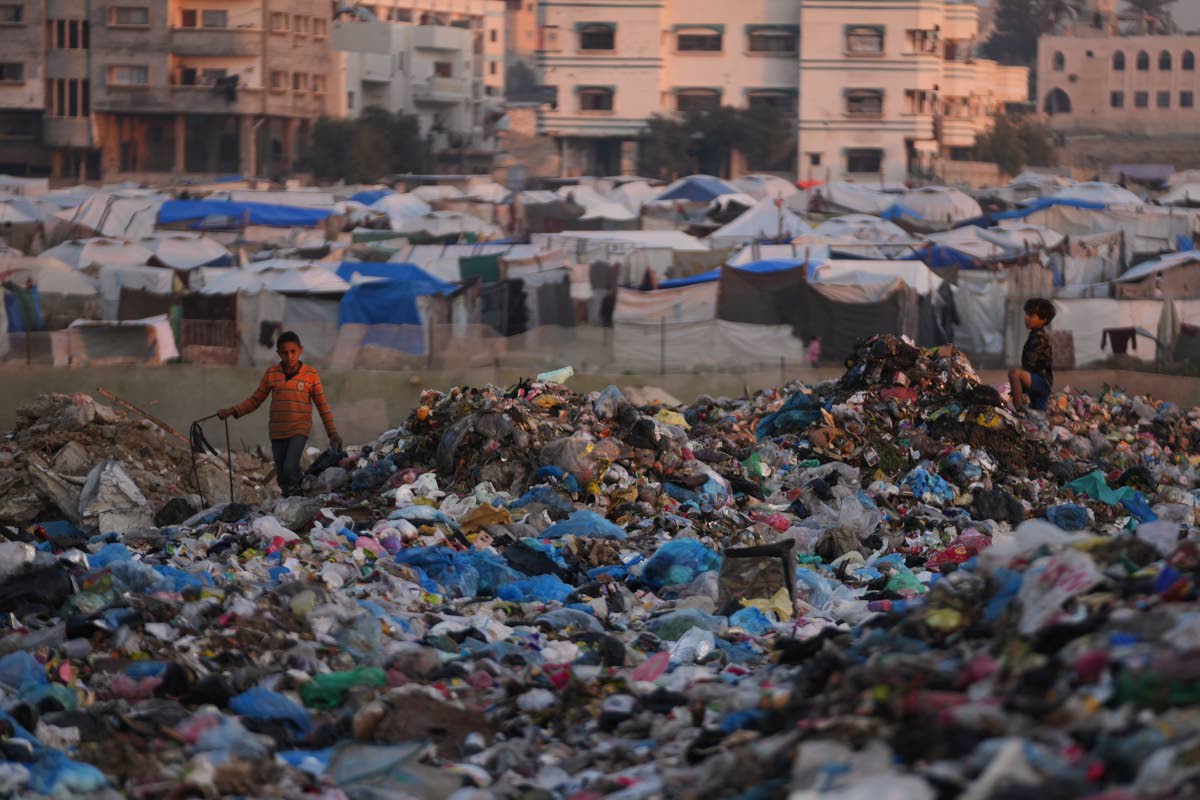 AP 
Children sort through trash at a landfill in al-Bureij camp, in the central Gaza Strip.