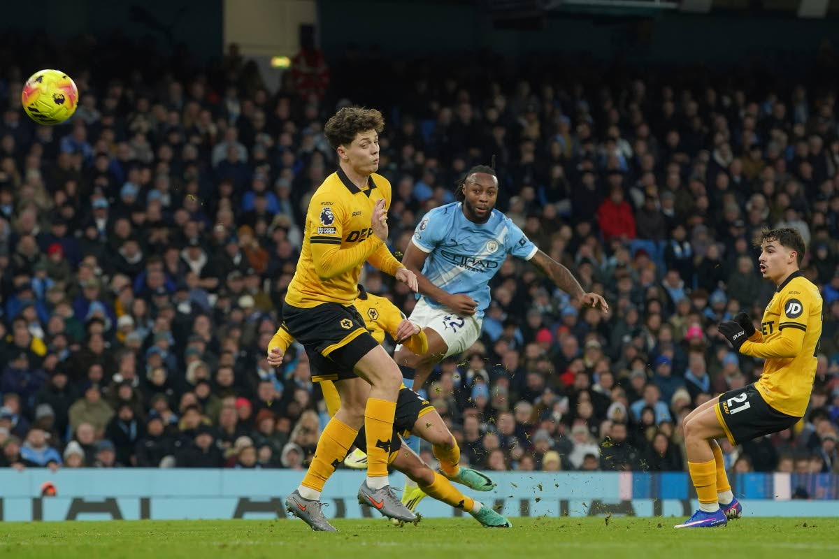 Manchester City’s Antoine Semenyo (centre) shoots and hits the bar during an English Premier League football match against Wolverhampton Wanderers in Manchester, England, yesterday.