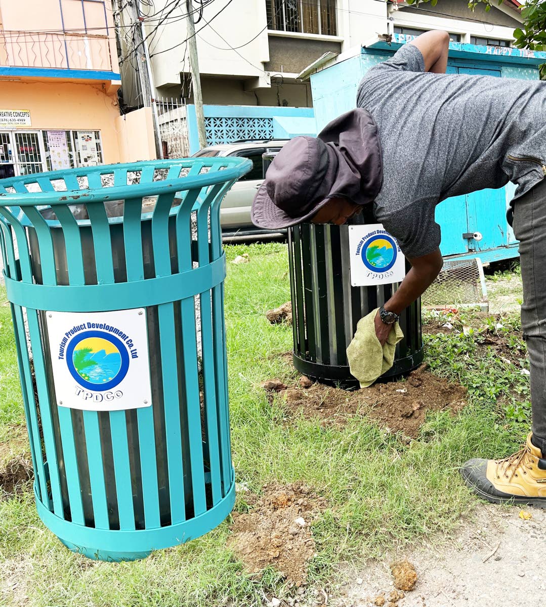 Technicians from the HEART/NSTA Trust work collaboratively to install a garbage receptacle in Ocho Rios, supporting a multi-agency effort to improve solid waste management and protect the environmental integrity of one of Jamaica’s major tourism destinat