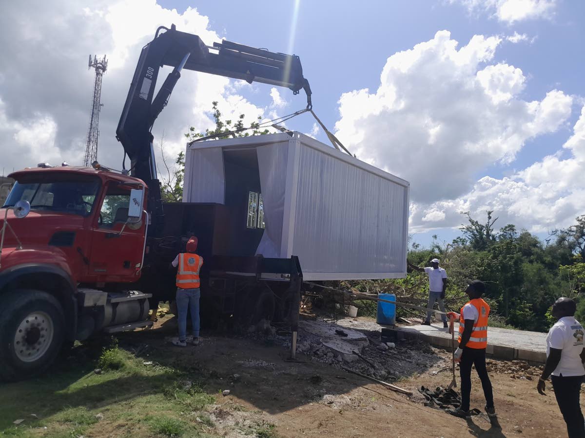 The container house being lowered into place in Pell River, Hanover.