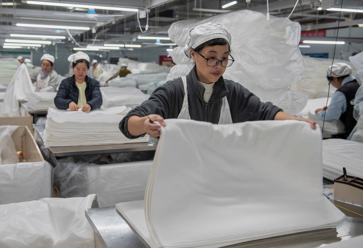 Workers labour on the production line of towels at a textile manufacturer in Huai’an city in east China’s Jiangsu province, Wednesday, April 2, 2025. AP
