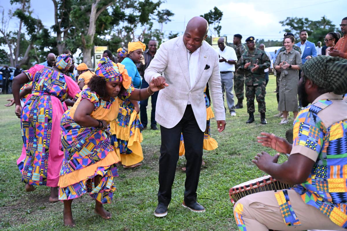 Minister of Foreign Affairs of the Republic of Ghana, Samuel Okudzeto Ablakwa (centre), dances with the Charles Town Maroon group during a welcome reception and tour at the Seville Great House in St Ann.