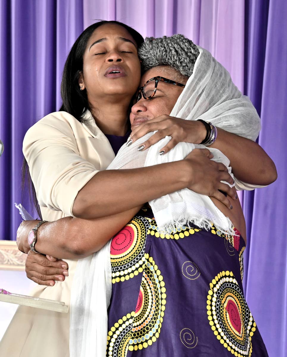 Arrayma Smith, (left) daughter of the late Garnet Silk hugs Bridgett Anderson.